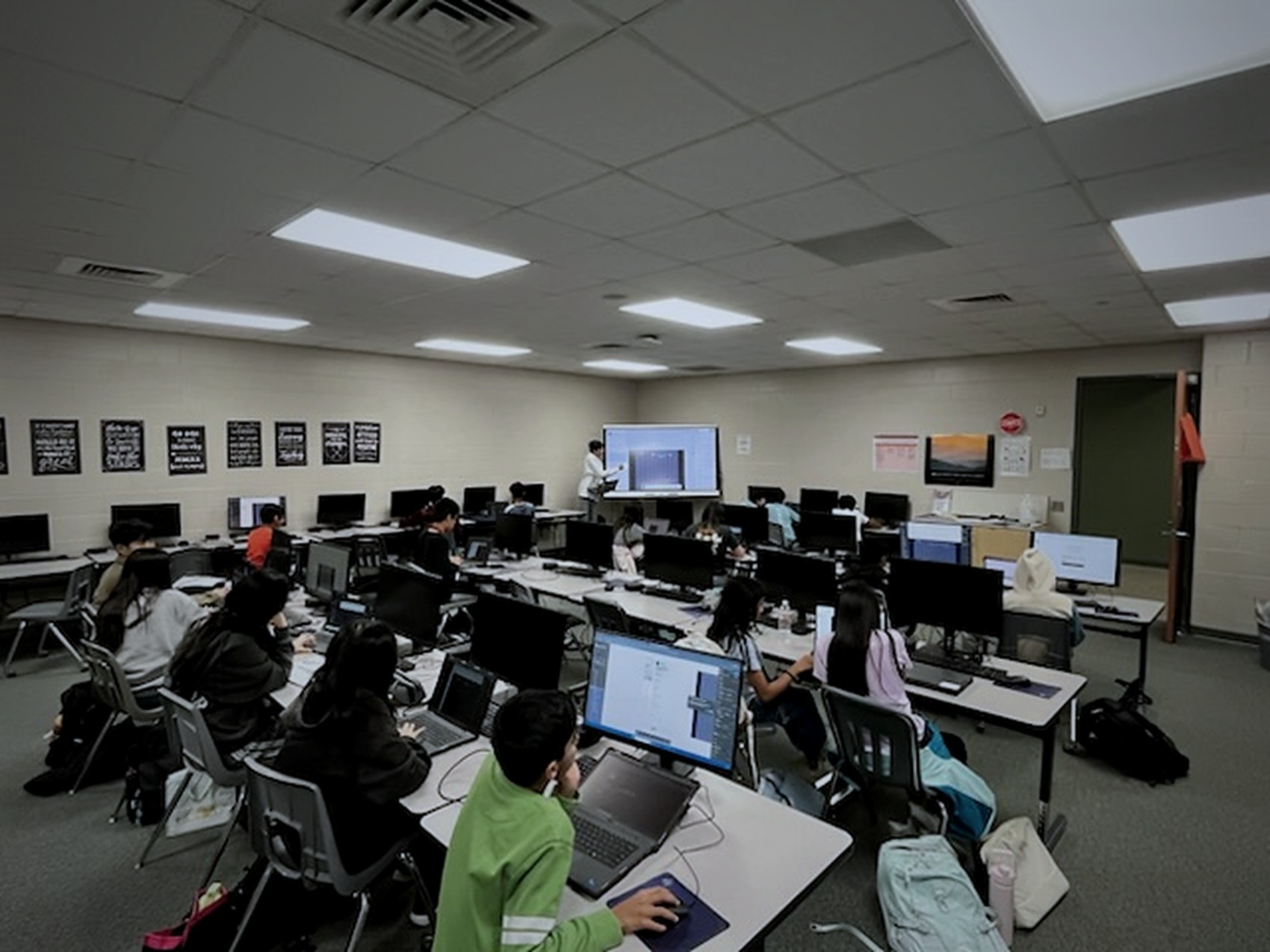 A full computer lab of students working during a Digital Design Club meeting
